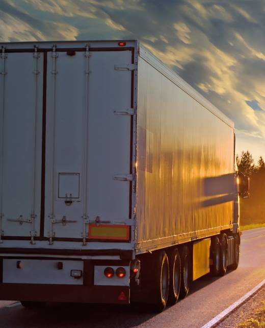 White truck on the rural road in evening